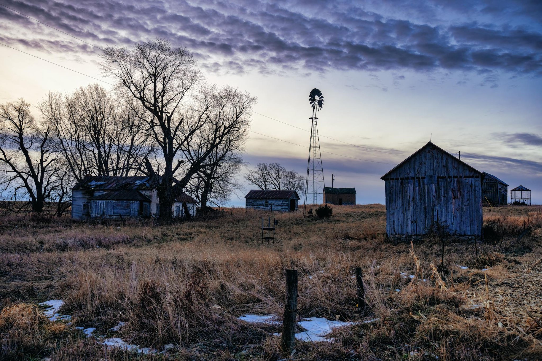 free-photo-of-windmill-near-wooden-barns.jpeg