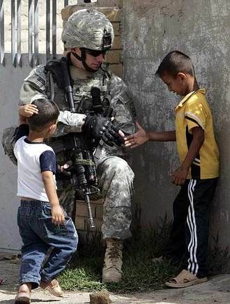 Iconic image of soldier shaking hand of Afghan child_.jpeg