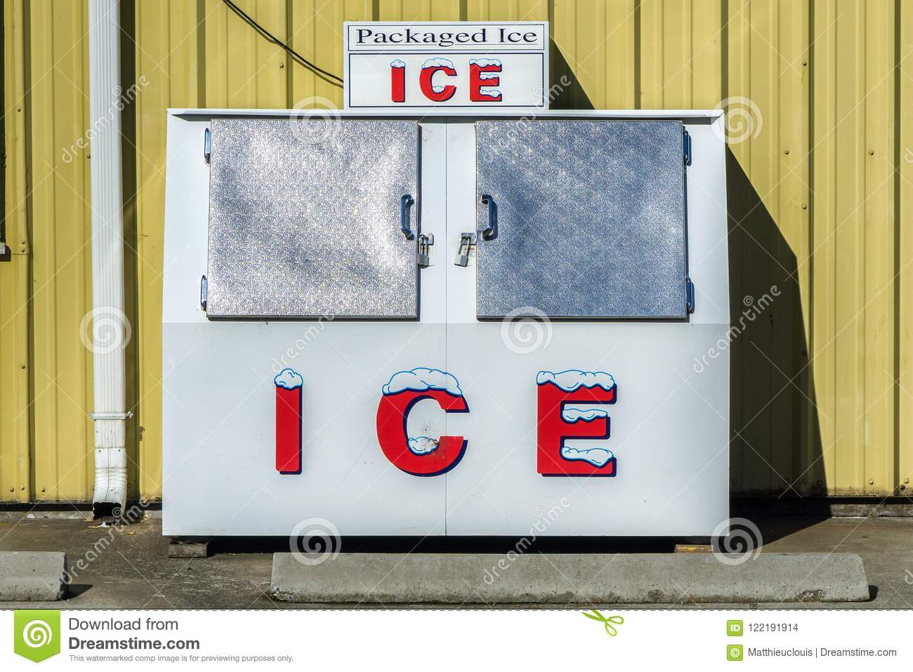 packaged-ice-freezer-machine-against-yellow-wall-hot-sunny-day-summer-outside-grocery-store-or...jpg