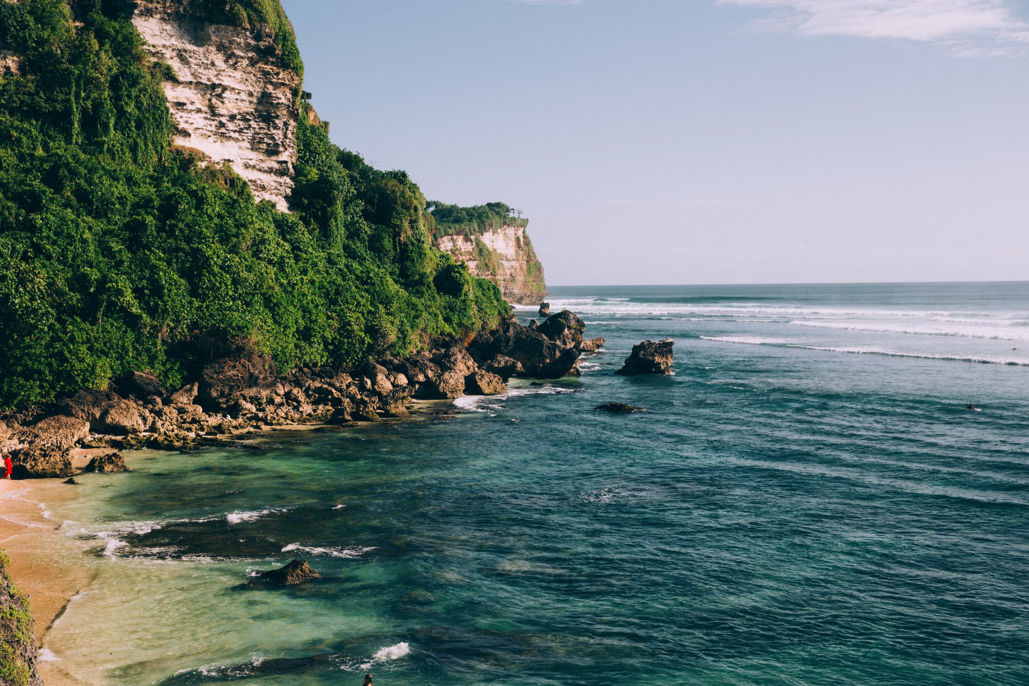 turquoise-blue-ocean-waters-along-jungle-covered-cliffside.jpg